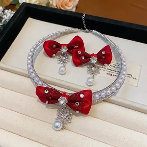 Elegant red silk bow jewelry set with sparkling rhinestone snowflakes and white pearl drops