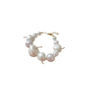Elegant French style cherry pearl necklace featuring white baroque beads with gold stems