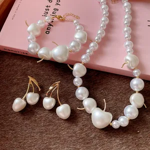 Detailed close-up of white cherry pearl jewelry set including necklace and earrings
