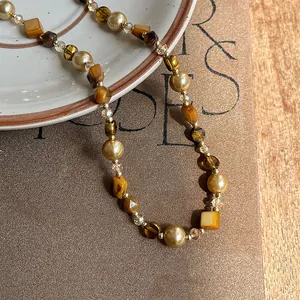 Exquisite detail of a vintage Maillard style necklace with tiger eye stones and pearls