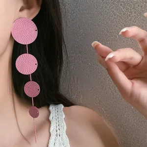 Close-up of pink four-disc textured drop earrings for women in a vintage chic style
