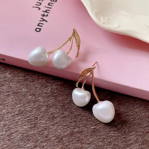 Elegant French style cherry earrings with white pearls and gold stems detail view