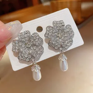 Exquisite silberne Blumenoherringe mit Strasssteinen und eleganten Tropfenperlen-Anhängern