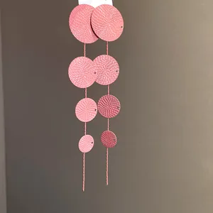 Detailed macro view of retro pink textured multi-disc tassel earrings for elegant women