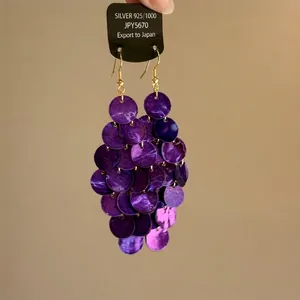 Detailed view of vintage purple tiered disc drop earrings on a 925 silver card