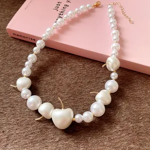 Close-up of elegant French style pearl necklace with unique cherry-shaped pearl charms