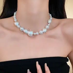 Close-up of elegant pearl necklace with unique cherry-shaped beads on model