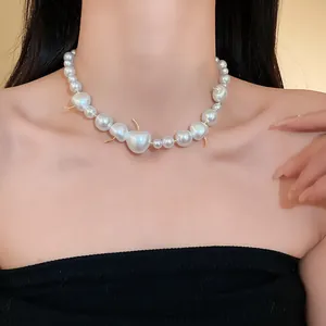 Detail of French style cherry pearl necklace worn on model's neck for elegant look