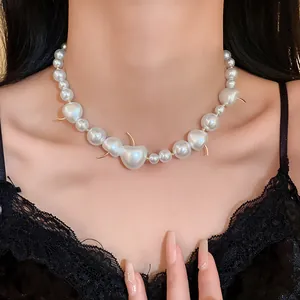 Close-up detail of elegant French style pearl necklace with unique cherry-shaped charms