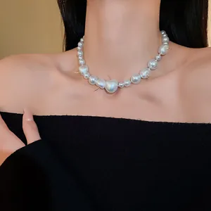 Elegant French style pearl necklace on neck featuring unique gold thorn accents.