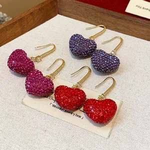Detailed view of luxury heart earrings with sparkling rhinestones in multiple colors