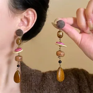 Vintage Maillard style long earrings with wooden beads and teardrop pendants macro view