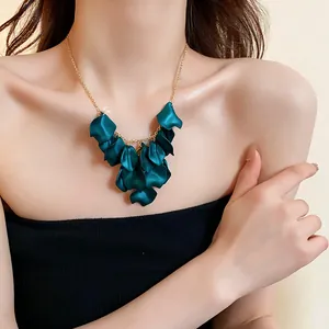 Détail rapproché d'un collier à pampilles de pétales vert foncé pour femme sur modèle