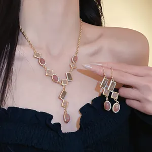 Elegant vintage geometric necklace and earrings set featuring rose stones and rhinestones