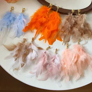 Detailed view of long fluffy feather tassel earrings in multiple vibrant soft colors