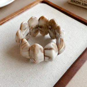Primo piano dettagliato che mostra la texture marmorizzata del bracciale in acrilico