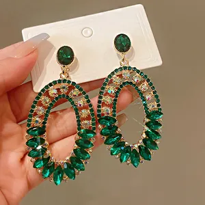 Detailed macro shot of vintage oval earrings set with shimmering green rhinestones