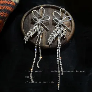 Long silver earrings with rhinestone heart bow and elegant tassel drop
