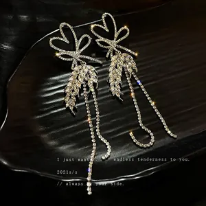 Elegant silver needle rhinestone heart earrings with long tassels and bow-knot design