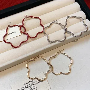 Elegant set of stylish flower-shaped hoop earrings in red, silver, and gold finishes