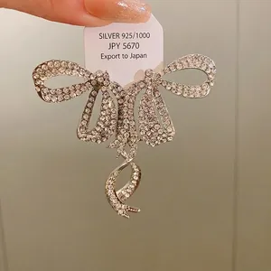 Sparkling rhinestone bow-knot tassel earrings with premium 925 silver needles.