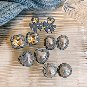 Detail of various vintage blue stud earrings with sparkling rhinestones and pearls