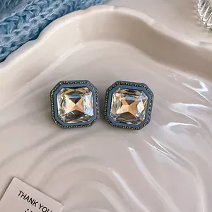 Macro view of elegant blue vintage square stud earrings with large sparkling crystals