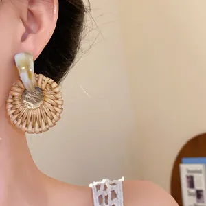 Nahaufnahme von handgefertigten Boho-Rattan-Ohrringen mit edlen Marmor-Details