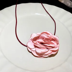 Elegant pink fabric rose flower necklace with adjustable burgundy cord for chic daily wear