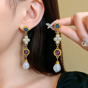 Vintage palace style gold-tone dangle earrings featuring pearls and colorful stones