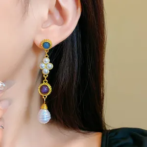 Close-up of vintage palace style drop earrings with colorful stones and pearls