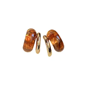 Geometric amber resin and gold plated earrings with vintage marbled pattern design.