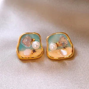 Close-up of elegant French vintage pearl earrings with a Monet garden inspired resin design