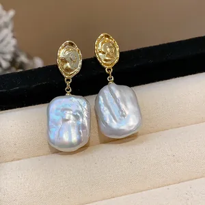 Dettaglio macro di orecchini a cammeo placcati oro 18k con perle barocche naturali