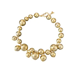 Bold statement gold beaded necklace with irregular polished metal spheres for women