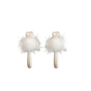 Elegant white faux pearl heart earrings with fluffy pom-poms for autumn and winter.