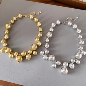 Detailed view showing gold and silver chunky bead necklaces with irregular designs