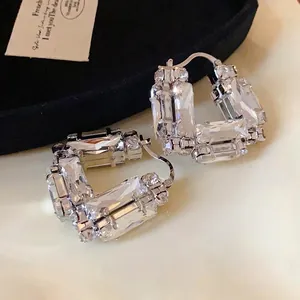 Elegant silver U-shaped hoop earrings encrusted with sparkling baguette-cut crystals