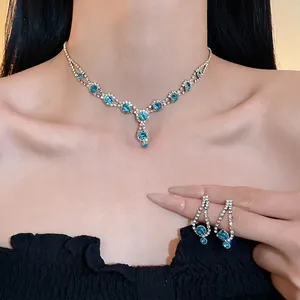 Elegant rhinestone jewelry set with blue gemstones including necklace and earrings
