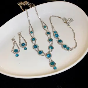 Sparkly turquoise rhinestone jewelry set with necklace, bracelet and earrings.