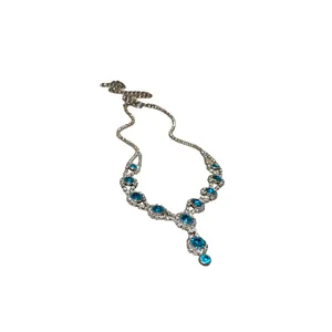Elegant silver-tone necklace with turquoise blue gemstones and sparkling crystals.