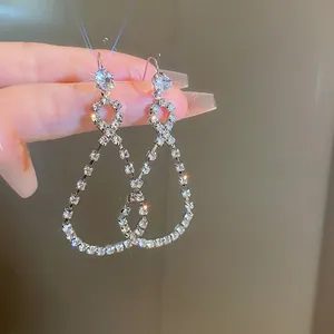 Detailed macro view showing the sparkling rhinestone teardrop drop earrings with silver needles
