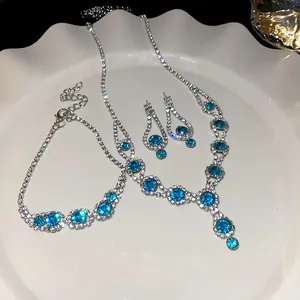 Detailed view of elegant blue rhinestone necklace, bracelet, and earring jewelry set