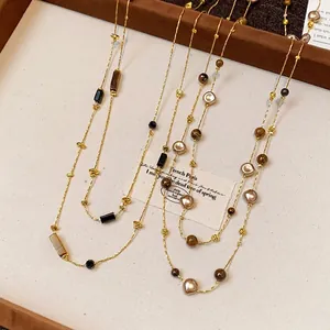 Elegant vintage irregular geometric beaded layered long sweater chain necklace on display