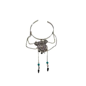 Vintage bohemian tassel arm cuff bracelet with turquoise beads and feather charms.
