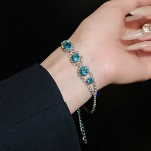 Close-up of a silver-toned bracelet featuring sparkling blue crystal flower details