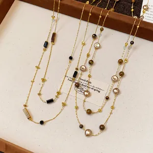 Close-up of vintage gold-tone sweater necklace with irregular beads and stones