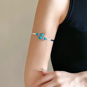 Vintage ethnic silver-toned armlet cuff with blue stones shown on model's upper arm
