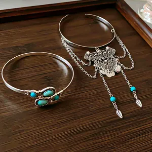 Close-up of boho silver cuff bracelet and armlet set with turquoise beads and tassels