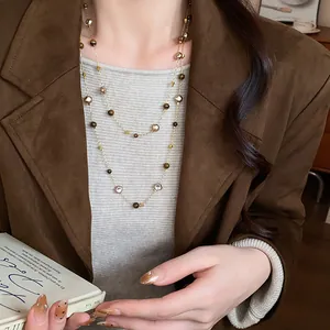 Detail view of retro double-layer necklace with irregular geometric beads and tiger eye.